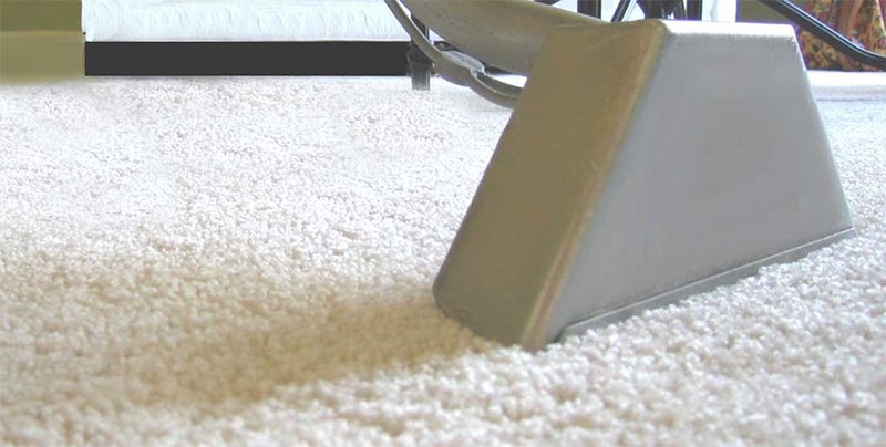 Close up of a carpet cleaning head on freshly cleaned carpet